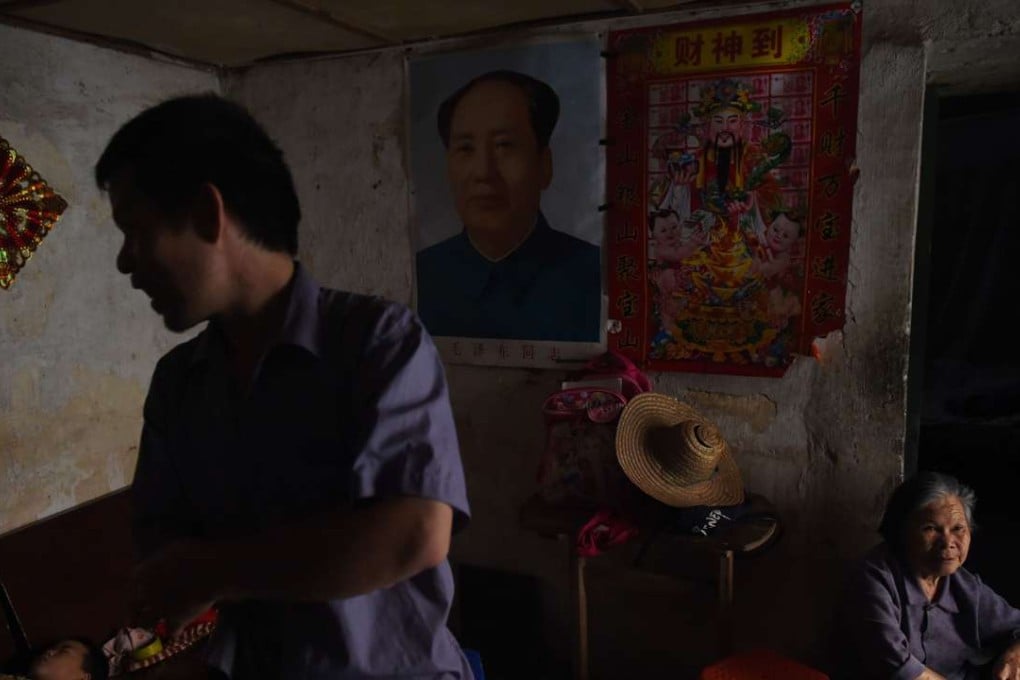 A family home in Wuxuan with a picture of Mao Zedong hanging on the wall. Mao launched the Cultural Revolution, which caused a decade of political turmoil in China. Photo: AFP