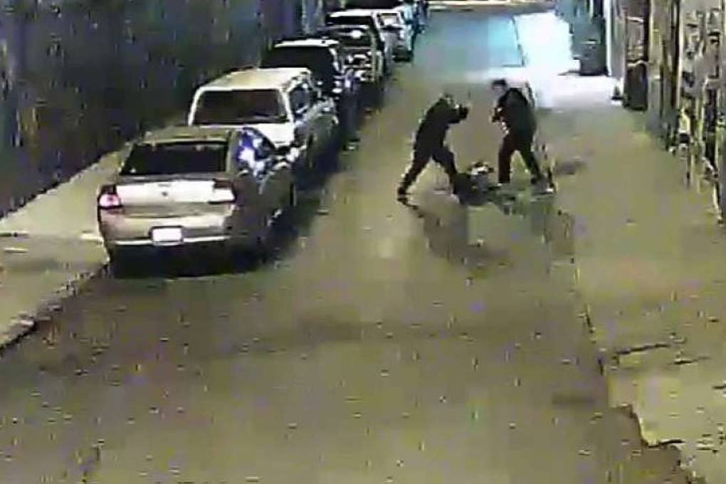 The two officers are seen beating Stanislav Petrov with batons as he lies prone in an alleyway. Photo: San Francisco Public Defenders Office