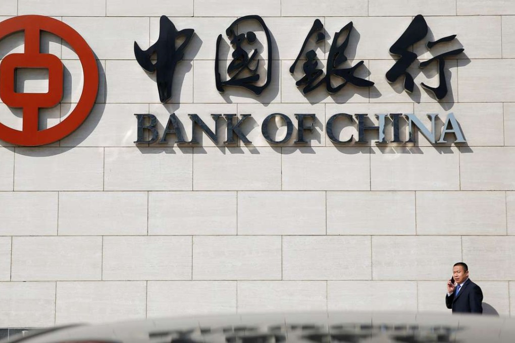 A man speaks on the phone outside the Bank of China headquarters in Beijing. Photo: Reuters