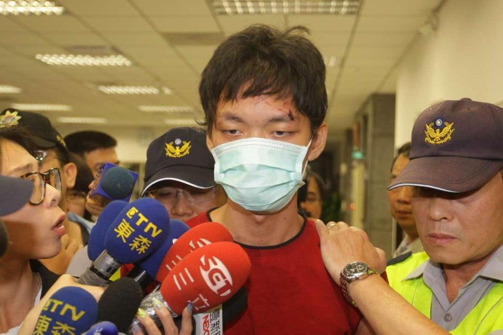 A filel photo of Cheng Chieh (centre) being transferred by policemen at a local police station in New Taipei City on May 22, 2014. Photo: AFP
