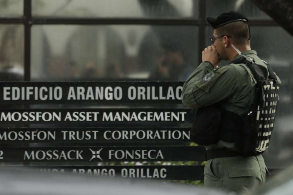 A police officer stands outside the Panama City offices of the Mossack Fonseca law firm while organized crime prosecutors raid the offices last month. Photo: AP