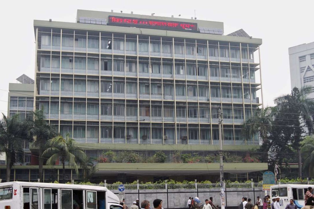 Commuters pass by the front of the Bangladesh central bank building in Dhaka. Photo: Reuters