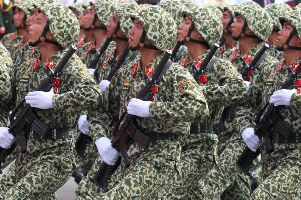 Soldiers hold rifles while marching during a celebration to mark Reunification Day in Ho Chi Minh city, Vietnam April 30, 2015. REUTERS/Kham