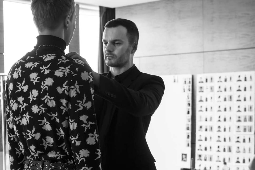 Dior Homme creative director Kris van Assche makes adjustments before last month’s catwalk show in Hong Kong. Photo: Hiroaki Fukuda