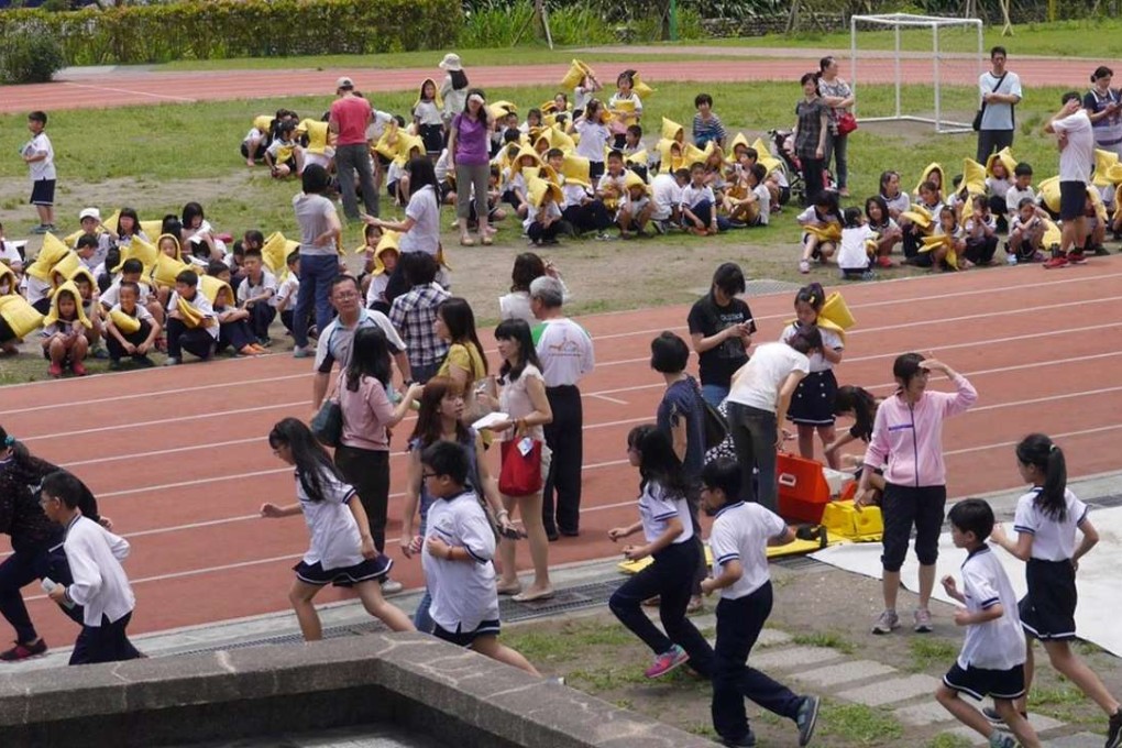 Teachers and pupils at Guang Fu Primary School rush to safety during the earthquake in northeastern Taiwan’s Yilan county. Photo: SCMP Pictures