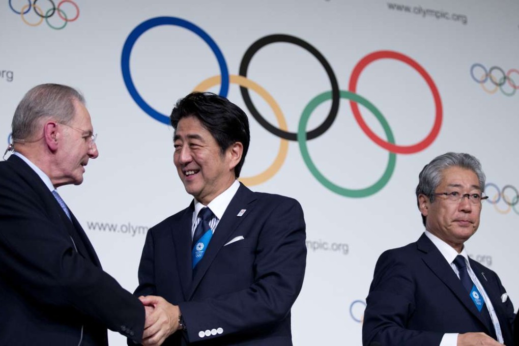 Japan's Prime Minister Shinzo Abe, center, shakes hands with President of the International Olympic Committee Jacques Rogge after signing the Host City Contract for the 2020 Olympic Games. A shell company in Singapore is increasingly emerging at the heart of what French prosecutors believe was an organised web of corruption in sports, with their suspicions now extending to Tokyo’s winning bid for the 2020 Olympics. Photo: AP