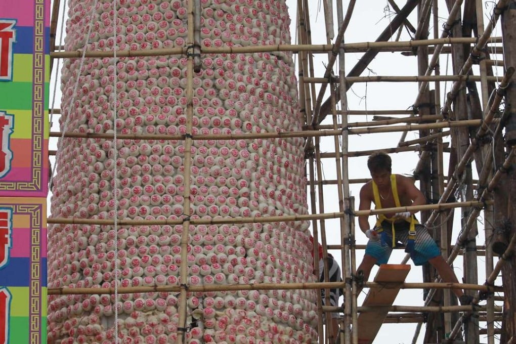 Workers set up the bun tower for the festival last year. Photo: SCMP Pictures