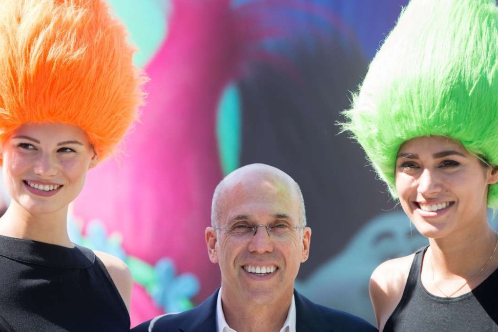 DreamWorks boss Jeffrey Katzenberg poses with two models in Berlin, Germany while promoting Trolls. Photos: EPA