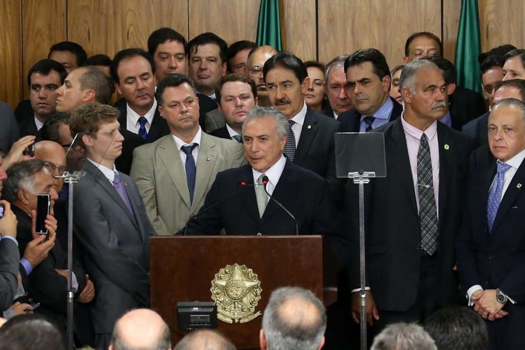 Michel Temer, Brazil's acting president, centre, is surrounded by members of his all-male cabinet at an event in Brasilia on Thursday. Photo: Reuters