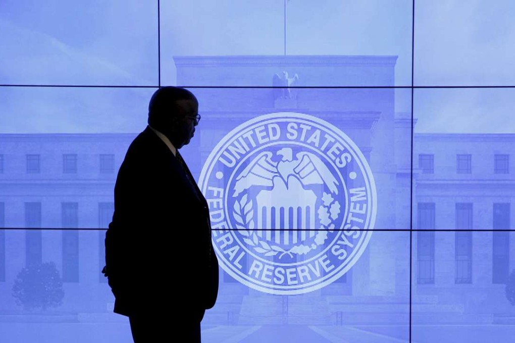 A security guard walks in front of an image of the US Federal Reserve in Washington. The Fed has no control over money outside its borders. Photo: Reuters