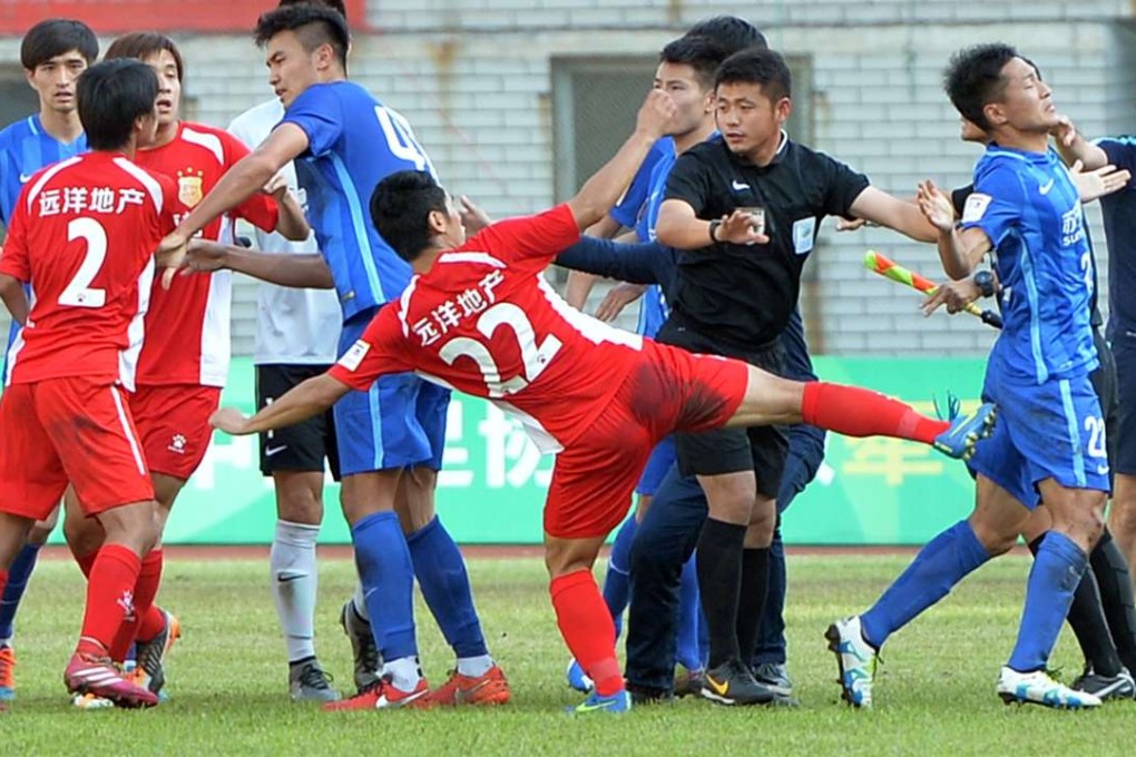 Chai Lei (22) of Wuhan Hongxing kicks the back of Wu Xi from Jiangsu Suning at the end of their Chinese FA Cup football match in Wuhan, in central Hubei province. Photo: AFP