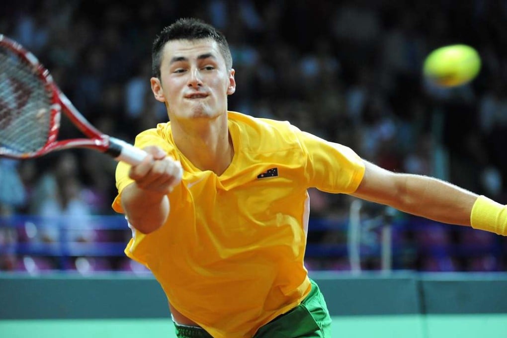 Bernard Tomic in the green and gold of Australia, but he won’t be wearing it this summer. Photo: EPA