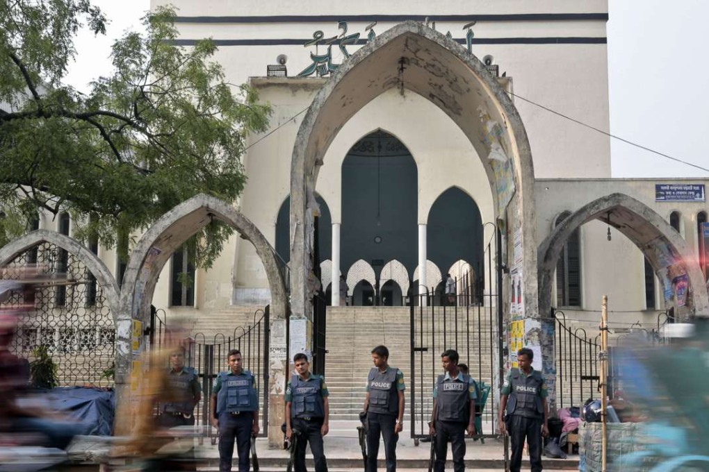 Bangladeshi policemen stand guard at the entrance to the National Mosque. Photo: AP