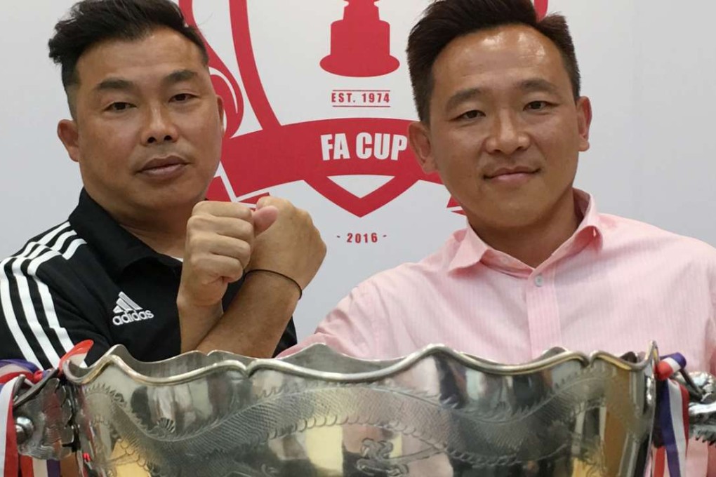 Pegasus coach Lee Chi-kin (left) and his Yuen Long counterpart Fung Hoi-man, pose in front of the FA Cup trophy ahead of the final on Sunday. Photo: SCMP/Chan Kin-wa