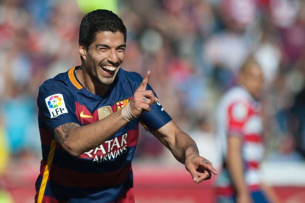 Luis Suarez celebrates after scoring his third goal against Granada. Photo: AFP