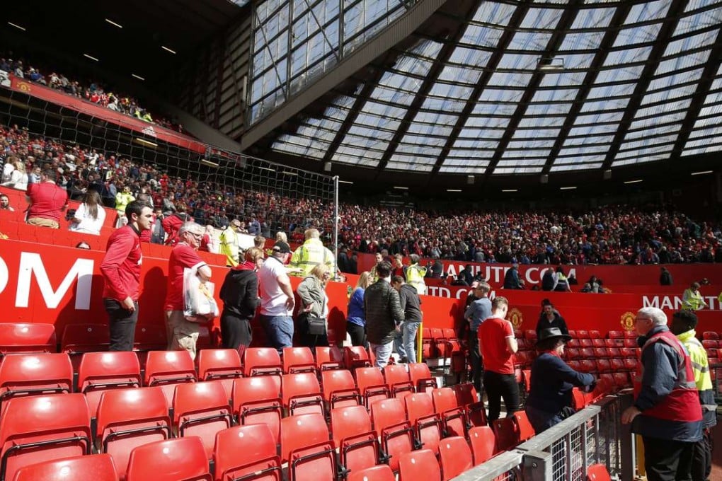 Football fans at Old Trafford evacuate the ground after the discovery of a suspect device. Photo: Reuters