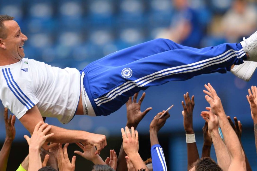 Chelsea captain John Terry is thrown in the air by teammates after the 1-1 draw with new champions Leicester City at Stamford Bridge. Terry, suspended for the game, said: “I want to stay. The club knows that, the fans know that.” Photo: AFP