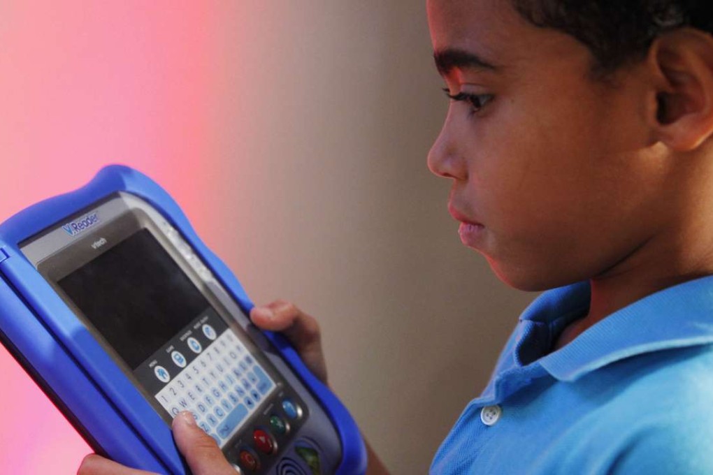 A boy looks at VTech's V.Reader, an interactive e-reader for children. Photo: AP