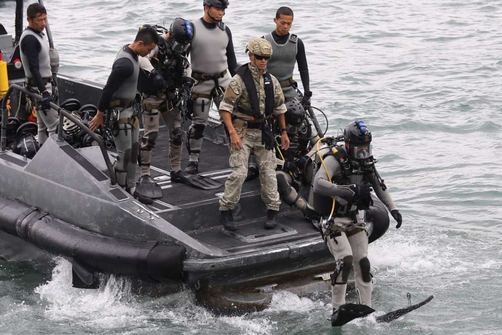 Police divers inspect the waters near the Convention and Exhibition Centre in Wan Chai. Photo: Dickson Lee