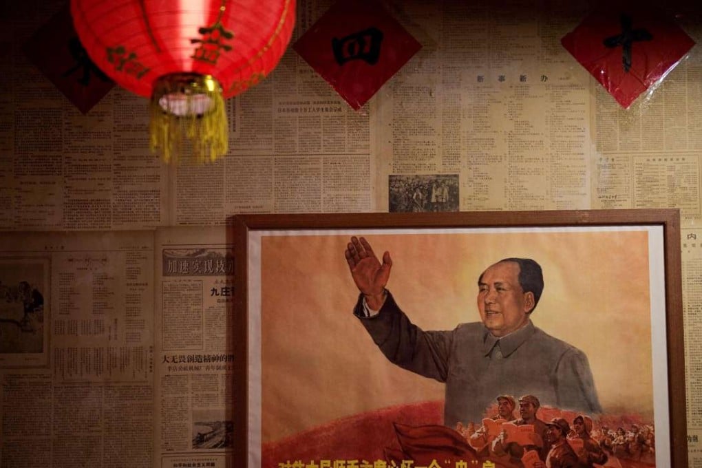 A poster showing the late Chinese chairman Mao Zedong hangs on a wall inside a restaurant in Beijing. Photo: AFP