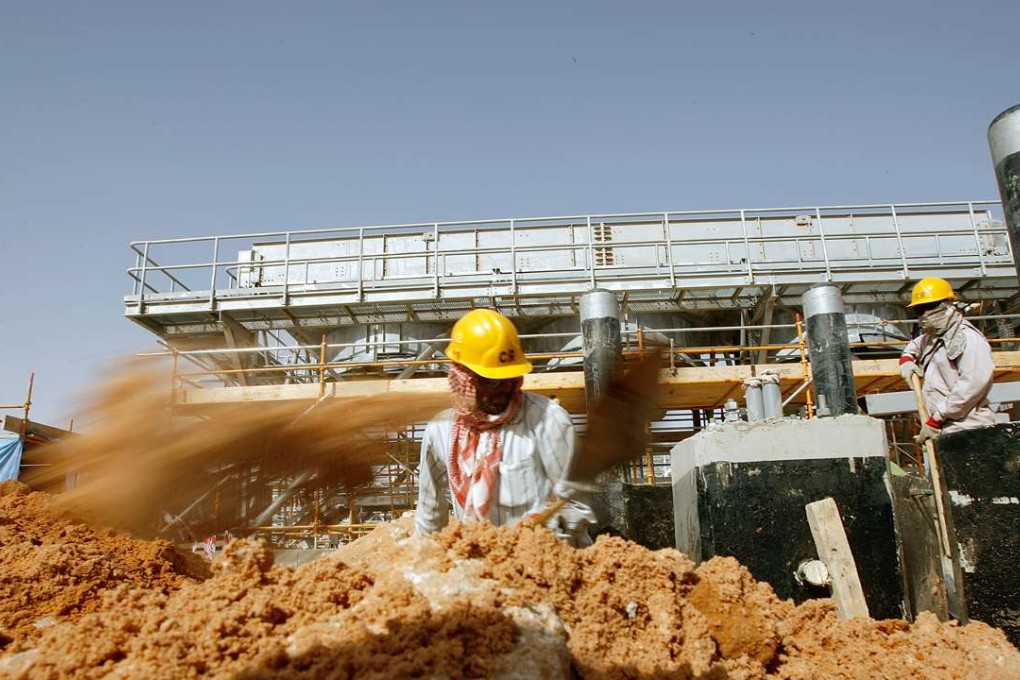 Labourers at work at the site of Saudi Aramco's central oil processing facility in al-Khurais in the Saudi Arabian desert. Photo: AFP