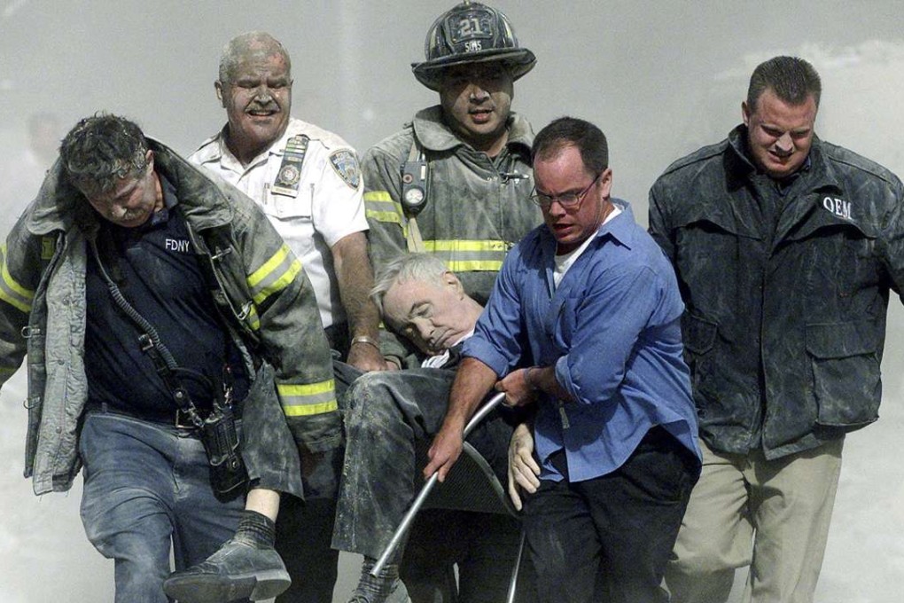 Police, firemen and a civilian carry the body of FDNY Chaplain Mychal Judge after he was killed in the collapse of the south tower at the World Trade Center in New York on September 11, 2001. Photo: reuters