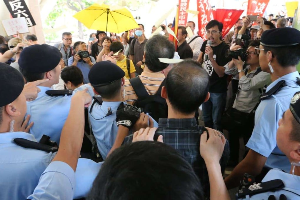 Police and protesters face off at the designated protest area near Central Plaza in Wan Chai. Photo: Felix Wong