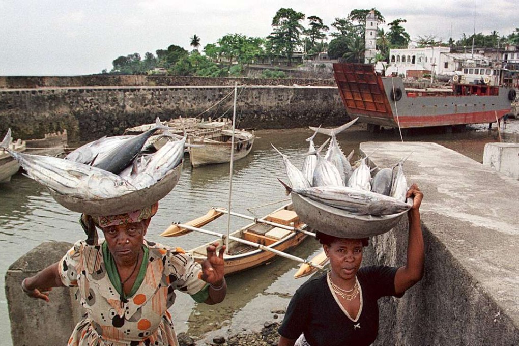 Two women struggle up the stairs at the dosck in the centre of the Comoros capital of Moroni. The impoverished nation has a per capita GDP of about US$810 per year. Photo: AFP