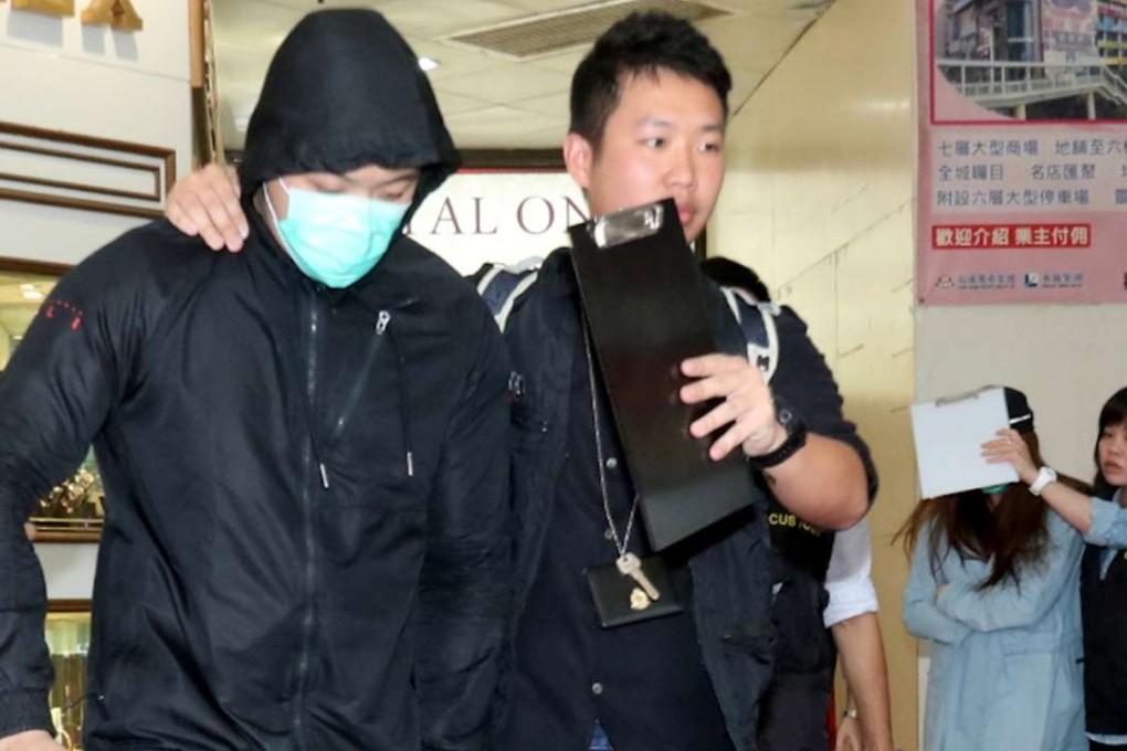 A Customs officer lead a worker from the gym. Photo: SCMP Pictures