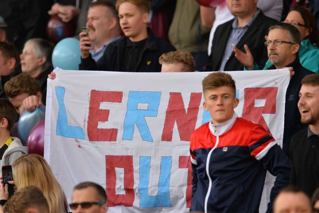 Aston Villa fans hold up a banner calling for the departure of then chairman Randy Lerner. Photo: AFP