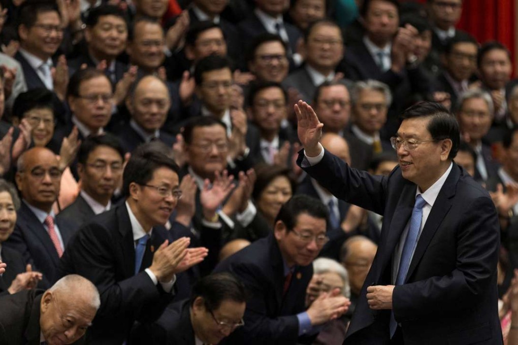 National People’s Congress chairman Zhang Dejiang (right) waves at the end of a meeting with about 220 guests from different sectors of Hong Kong at the central government offices at Tamar. Photo: Reuters