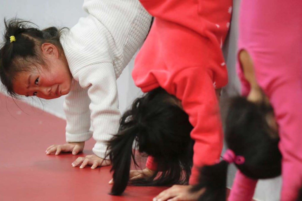 Children practise handstands during gymnastics lessons at the Shanghai Yangpu Youth Amateur Athletic School in Shanghai. Photo: Reuters