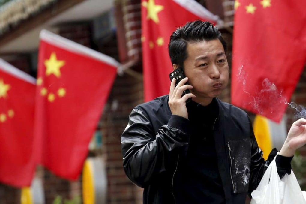 A man talks on his mobile phone in Beijing. Mainland police have intensified their efforts against telecoms scams in recent months. Photo: Reuters
