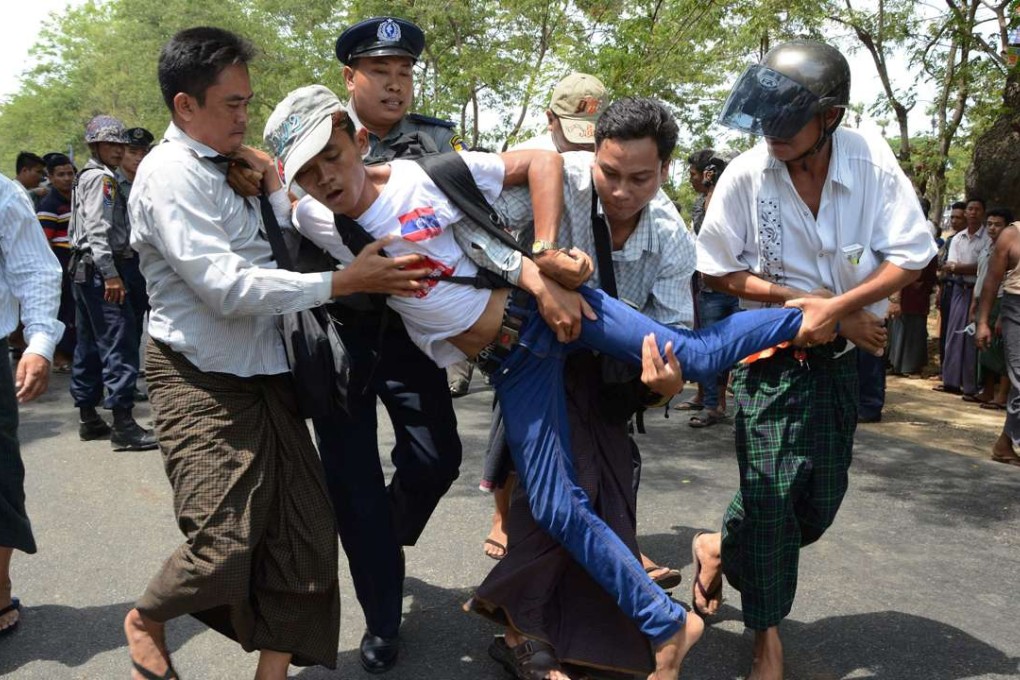 A demonstrator demanding labour rights is arrested by police in Tetkone township on May 18, 2016 during a workers protest march to central Naypyidaw. Photo: AFP