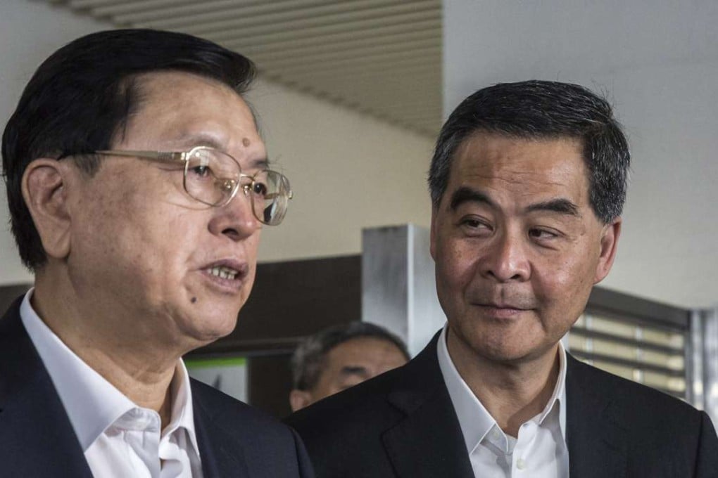 Hong Kong Chief Executive Leung Chun-ying, right, listens as Zhang Dejiang, chairman of China's National People's Congress speaks as they visit the foyer of a newly built public housing block due to open later this year in Hong Kong. Photo: SCMP Pictures