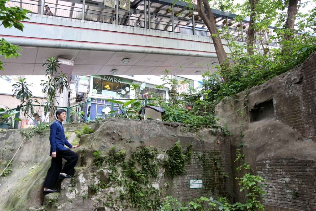 Central and Western Concern Group convenor Katty Law stands by the ruined tenement buildings. Photos: Nora Tam