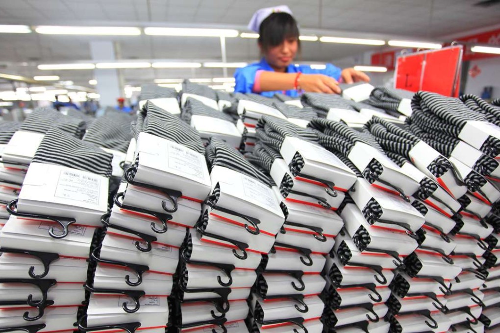 A worker arranges knitwear for export to Japan in a garment enterprise in Qingdao, Shandong Province. Family run textile businesses are now feeling the pressure to adjust to a consumer-driven economy. Photo: Xinhua