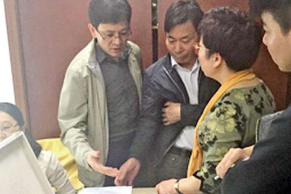 One of the victims show counterfeit beauty products to the investigating authorities. Photo: SCMP Pictures