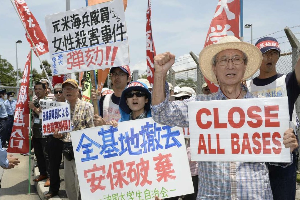 People protest in front of the US Kadena Air Base in Okinawa Prefecture on May 20, 2016, following the arrest the previous day of Kenneth Franklin Shinzato, a former U.S. Marine who is now a civilian worker at the air base, over the death of a 20-year-old local woman. Photo: Kyodo