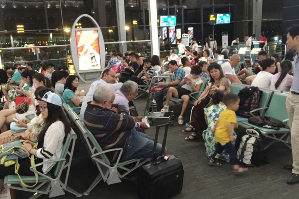 Passengers wait at Guangzhou Baiyun International Airport on Friday as more than 300 flights were cancelled because of inclement weather. Photo: SCMP Pictures