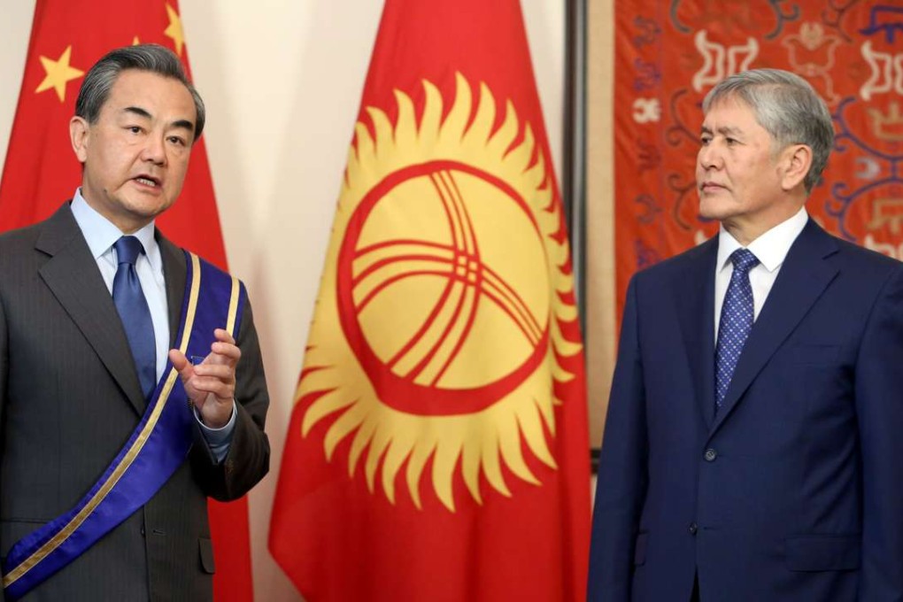 Chinese Foreign Minister Wang Yi receives the Order of Danaker from Kyrgyz Foreign Minister Erlan Abdyldayev prior their meeting in Bishkek, Kyrgyzstan. Photo: EPA