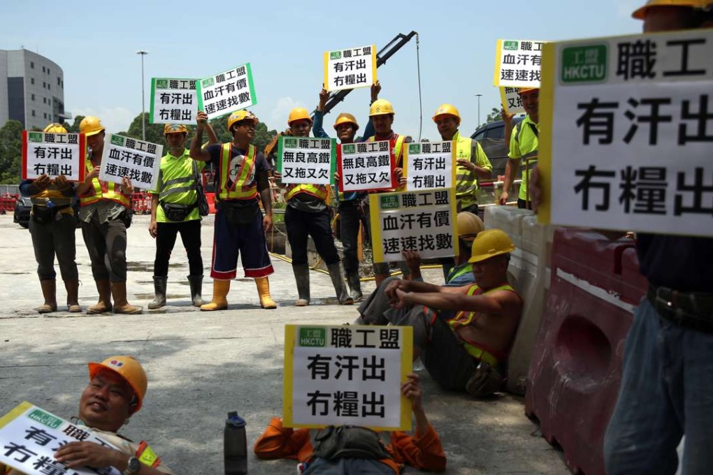Workers wave placards declaring “All Sweat No Pay”. Photo: Sam Tsang
