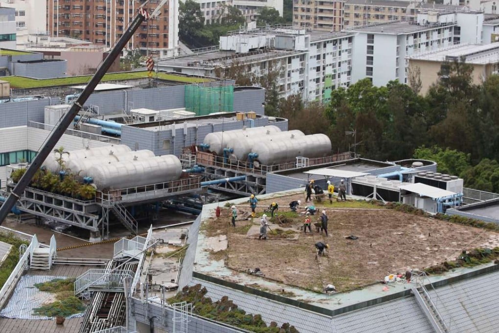 Government officials and worker take apart a rooftop garden neighbouring City University’s Hu Fa Kuang building, where a giant, green rooftop collapsed injuring three people. Photo: Sam Tsang