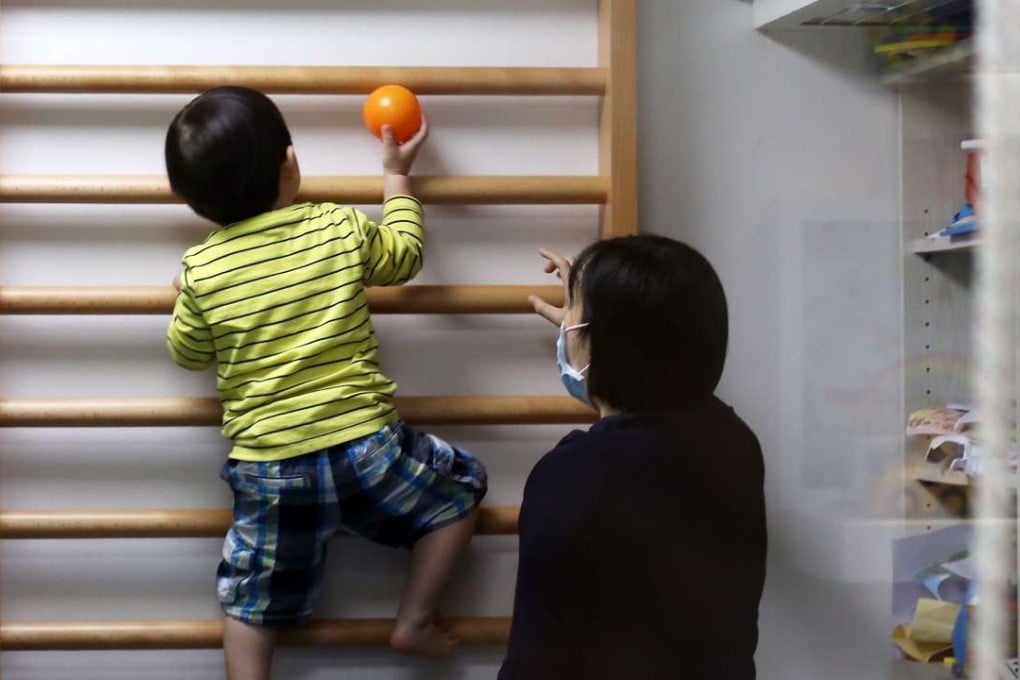 A registered occupational therapist works with an autistic child. Photo: Nora Tam