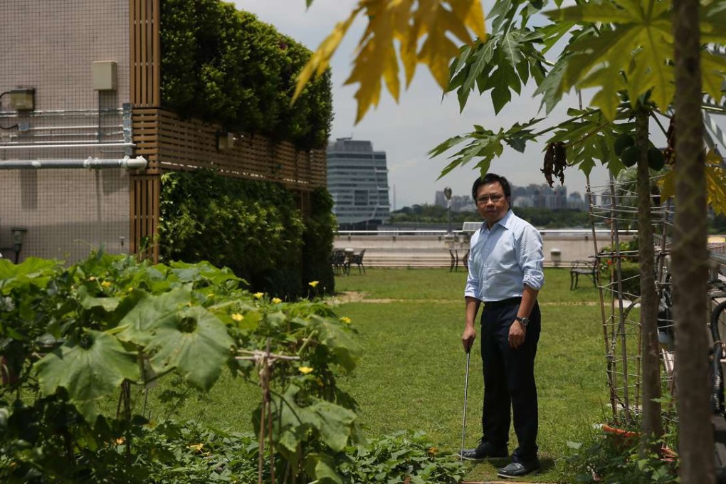 Former Institute of Surveyors president Vincent Ho inspects a Baptist University rooftop. Photo: Sam Tsang