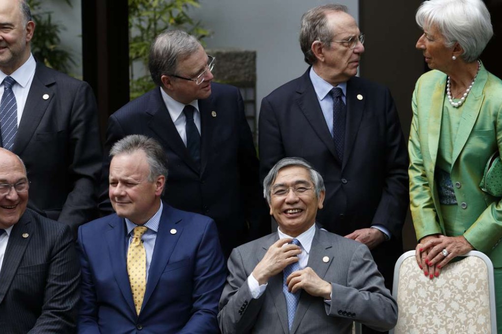 Haruhiko Kuroda, governor of the Bank of Japan, adjusts his tie during a photo session ahead of a meeting of G7 finance ministers and central bank governors in Sendai, Japan. Photo: Bloomberg