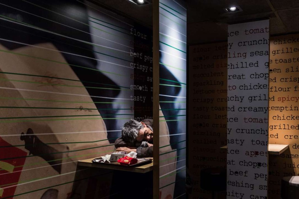 In this picture taken early on April 9, 2016, an elderly man rests his head on a table as he sleeps after finishing his meal at a McDonalds outlet in the Kowloon district of Hong Kong. Photo: AFP