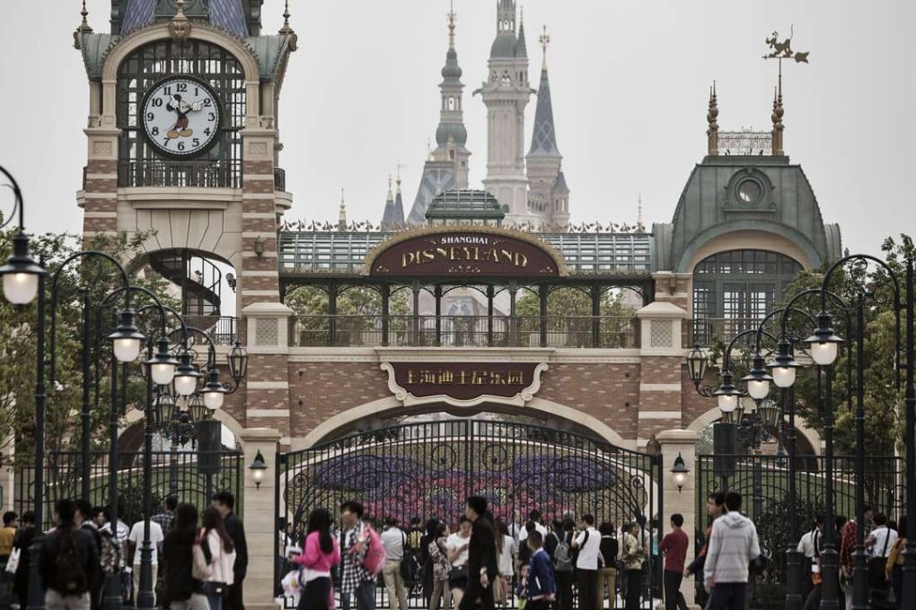 Visitors walk past a gate at Walt Disney's Disneyland Resort in Shanghai, which is due to open next month. Photo: Bloomberg