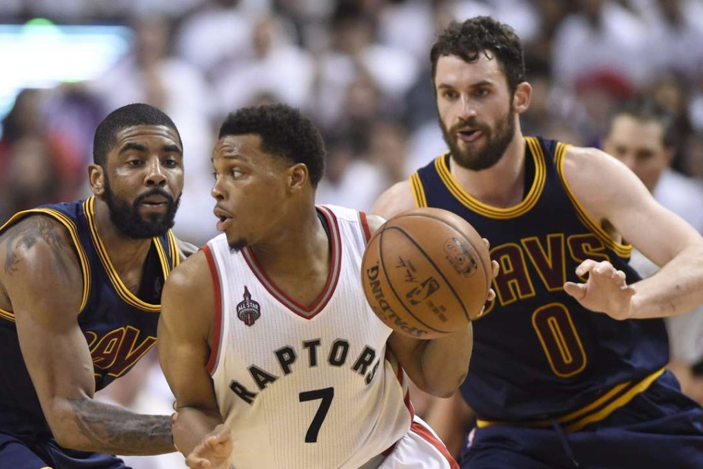 Kyle Lowry controls the ball as Kevin Love (0) and Kyrie Irving defend. Photo: AP