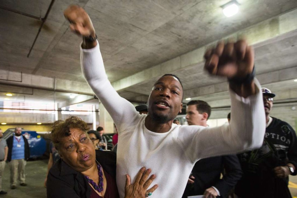 A protester screams at people leaving the Baltimore courthouse after police officer Edward Nero was acquitted of all charges in the death of Freddie Gray in Baltimore on Monday. Photo: EPA